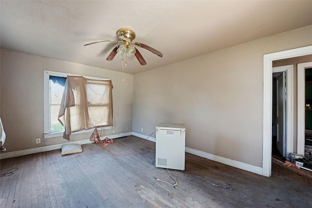 empty room featuring ceiling fan and dark wood-type flooring