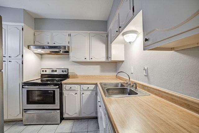 kitchen with stainless steel electric stove, sink, white cabinets, and light tile patterned flooring