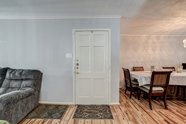 foyer entrance featuring light wood-type flooring and crown molding