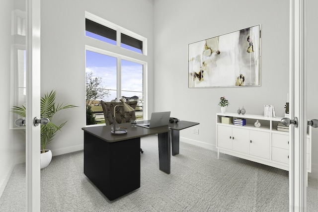 carpeted home office with french doors