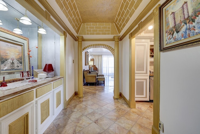 hallway with crown molding and vaulted ceiling