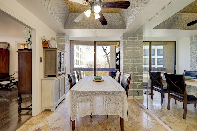 dining area featuring a tray ceiling and ceiling fan