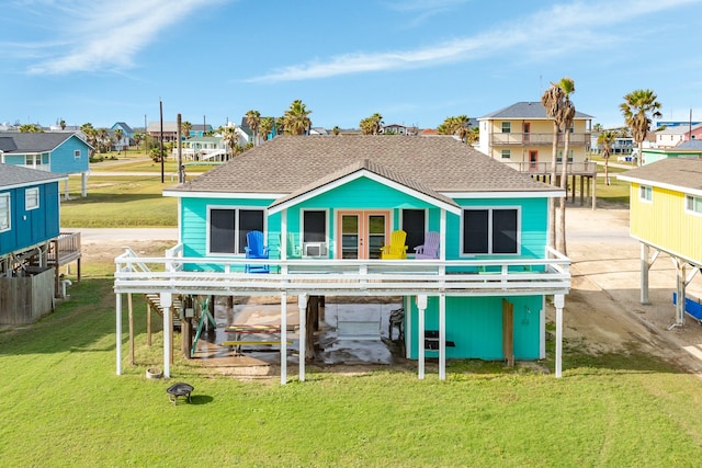 rear view of property featuring a lawn