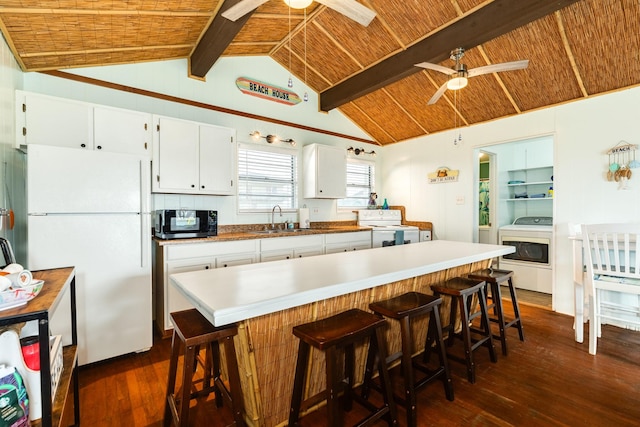 kitchen with dark hardwood / wood-style floors, white cabinetry, white appliances, and beam ceiling