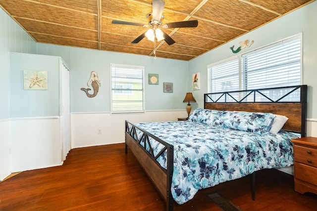 bedroom featuring multiple windows, ceiling fan, dark wood-type flooring, and wooden ceiling