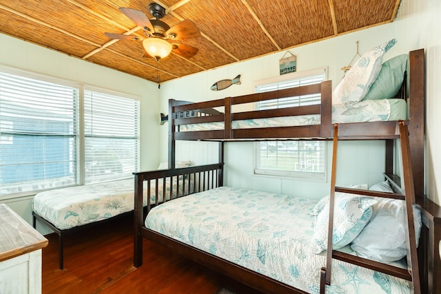 bedroom with wooden ceiling, ceiling fan, wood-type flooring, and multiple windows