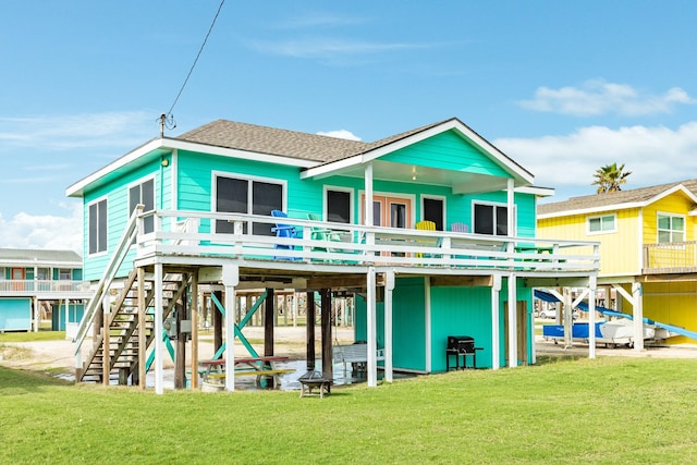 back of property with a yard and a deck