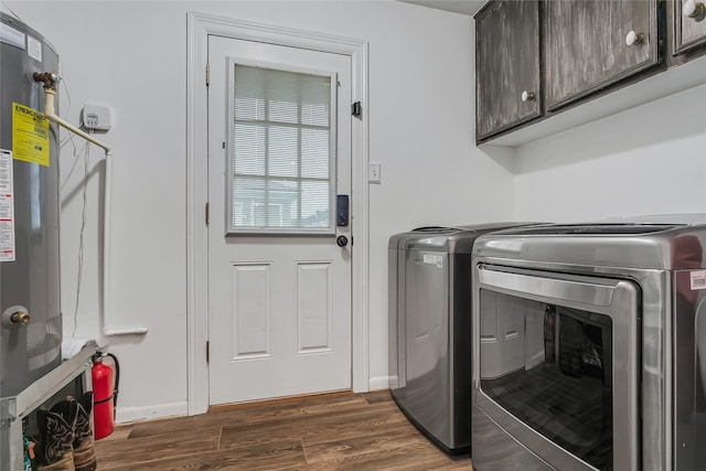 laundry room with dark wood-type flooring, independent washer and dryer, and cabinets