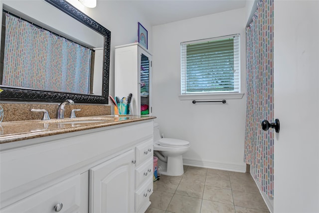 bathroom featuring tile patterned floors, vanity, and toilet