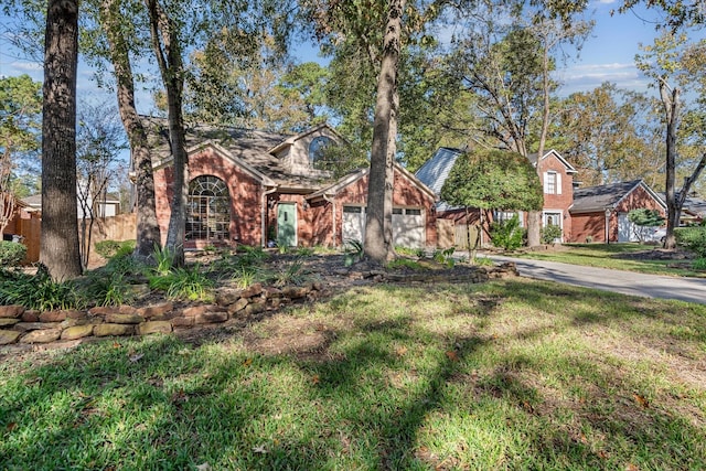 view of front of property with a front yard and a garage