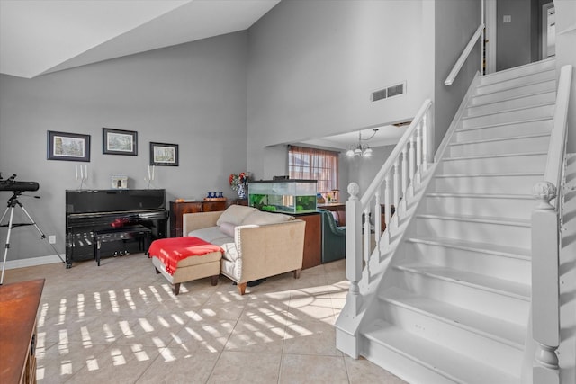 living room featuring light tile patterned floors, an inviting chandelier, and high vaulted ceiling