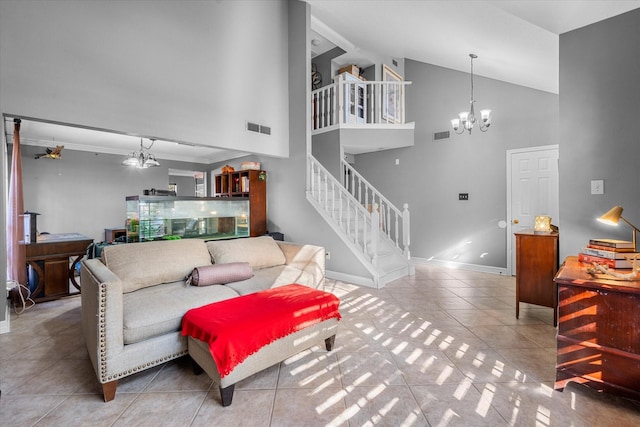 living room with tile patterned floors, high vaulted ceiling, and a chandelier