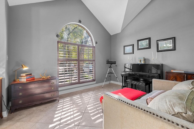 interior space featuring high vaulted ceiling and light tile patterned flooring