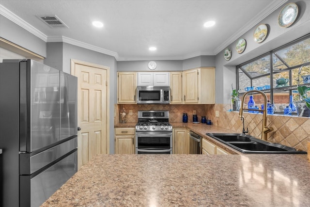 kitchen with sink, ornamental molding, stainless steel appliances, and tasteful backsplash