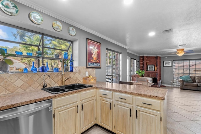 kitchen featuring dishwasher, crown molding, a fireplace, tasteful backsplash, and kitchen peninsula