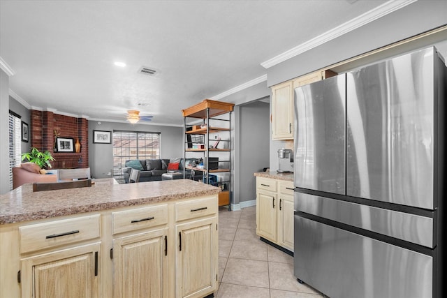 kitchen featuring ceiling fan, stainless steel fridge, light tile patterned flooring, and ornamental molding