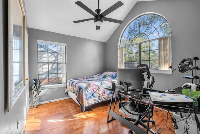 bedroom featuring ceiling fan, hardwood / wood-style floors, and vaulted ceiling