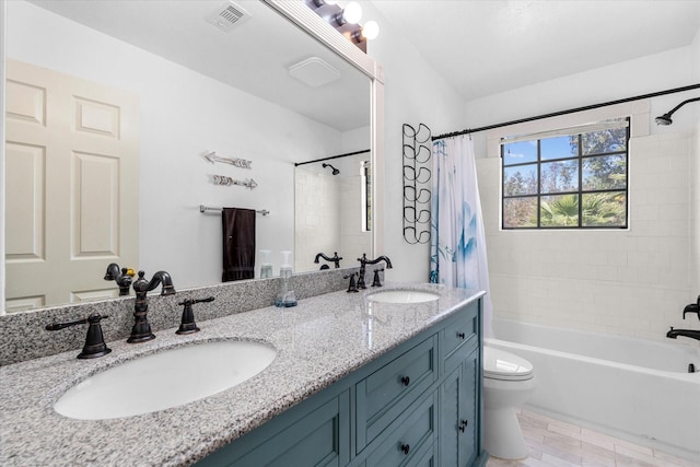 full bathroom with vanity, toilet, and shower / tub combo with curtain