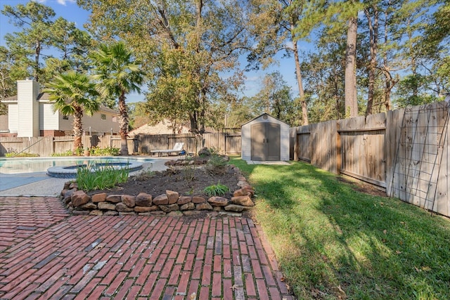 view of yard featuring a fenced in pool, a patio, and a storage shed