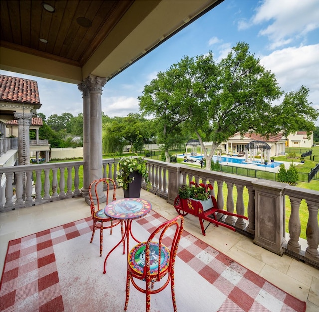 view of patio featuring covered porch and a pool