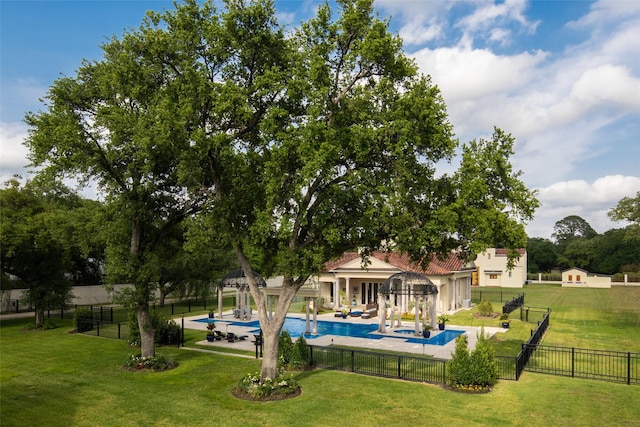 view of pool with a patio area and a yard