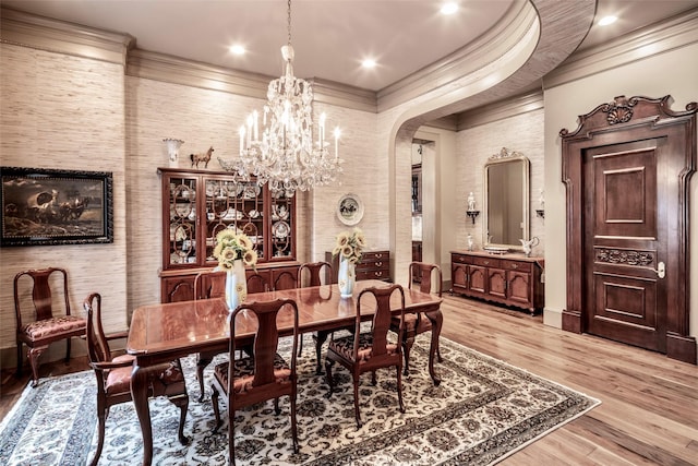 dining room featuring a chandelier, hardwood / wood-style floors, and ornamental molding