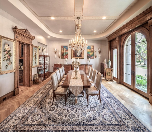 dining room with an inviting chandelier, french doors, and light parquet flooring