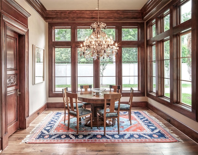 dining room with wood-type flooring, a wealth of natural light, and a chandelier