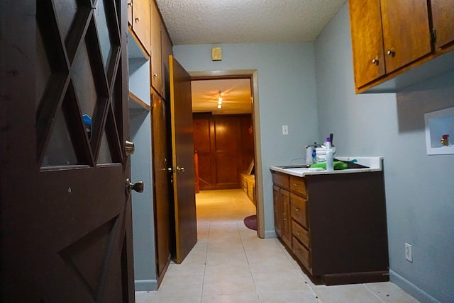 bathroom with tile patterned flooring and a textured ceiling