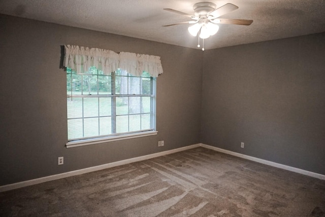 carpeted spare room featuring a textured ceiling and ceiling fan