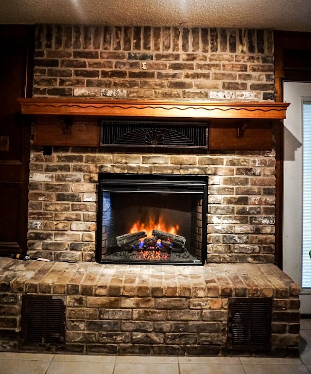 interior details featuring a fireplace and a textured ceiling