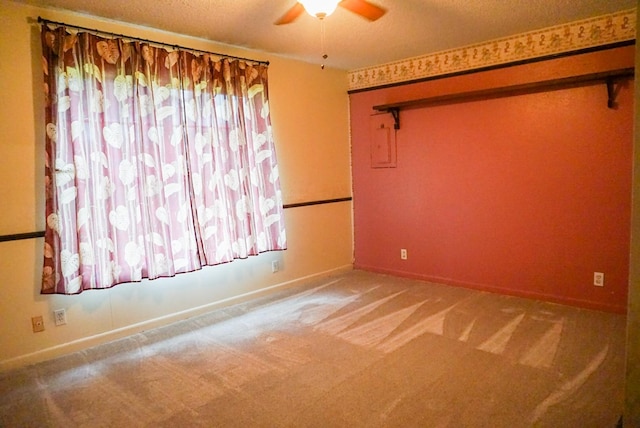 unfurnished room with carpet flooring, a textured ceiling, and ceiling fan