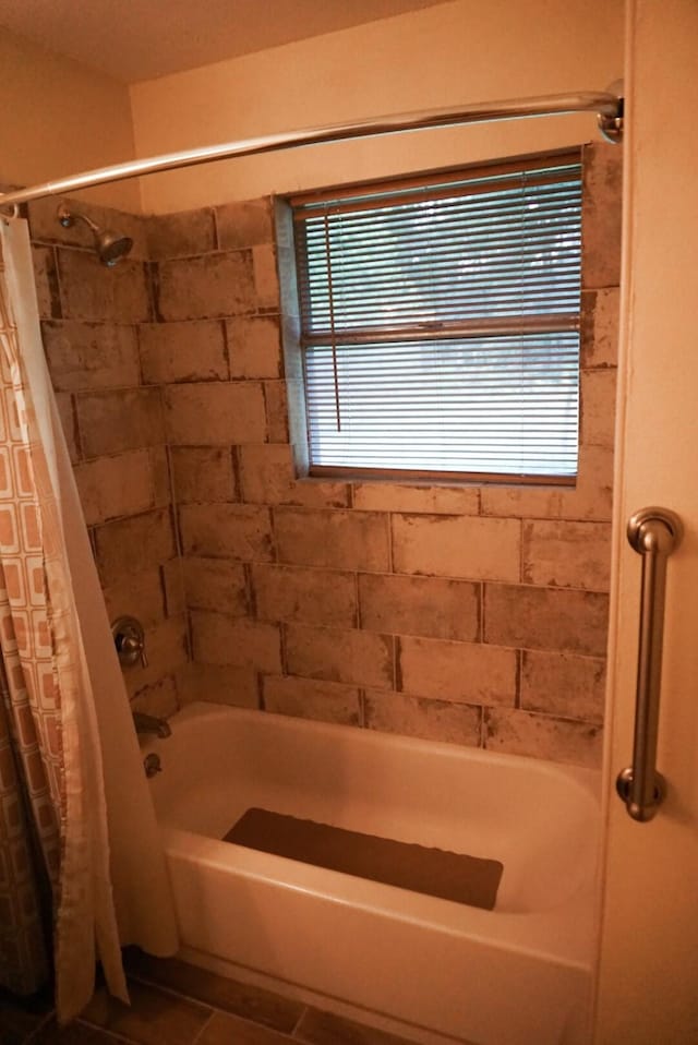 bathroom featuring tile patterned floors and shower / bath combo with shower curtain