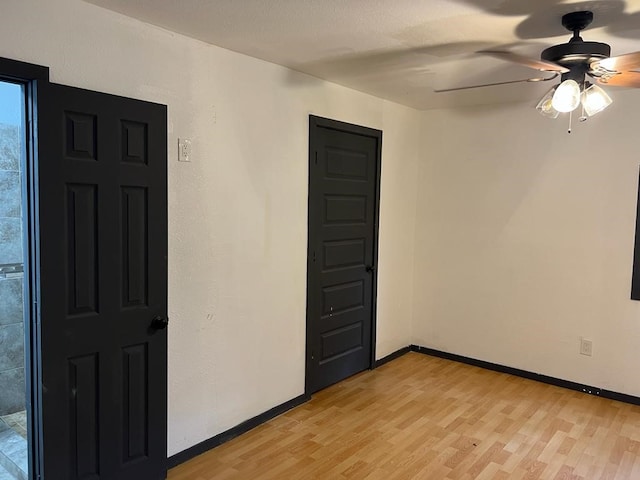 unfurnished room featuring ceiling fan and light wood-type flooring