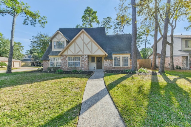 english style home with a front yard