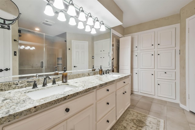 bathroom with tile patterned flooring, vanity, and an enclosed shower