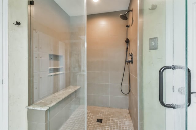 bathroom with a shower with shower door