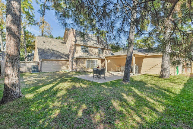 back of house with a patio and a yard