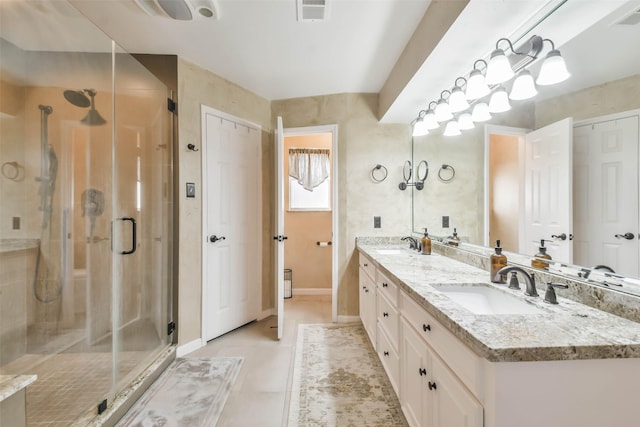 bathroom featuring vanity, an enclosed shower, and tile patterned floors