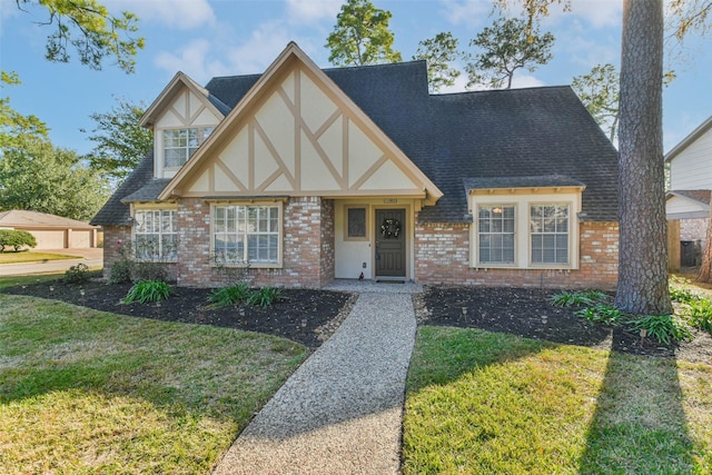 english style home with a front lawn