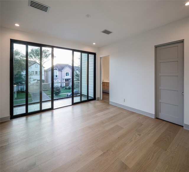 unfurnished room with light hardwood / wood-style floors