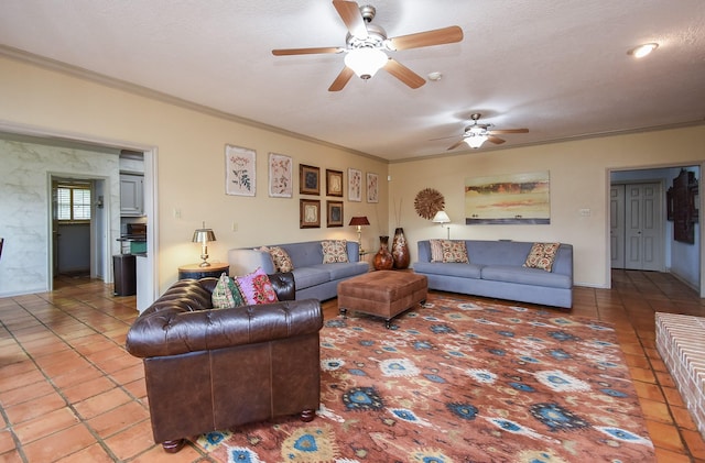 living room featuring ceiling fan, crown molding, tile patterned floors, and a textured ceiling