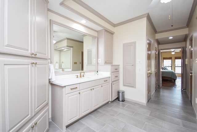 bathroom featuring vanity, ornamental molding, and ceiling fan