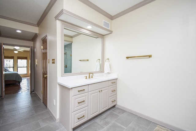 bathroom featuring ceiling fan, ornamental molding, and vanity