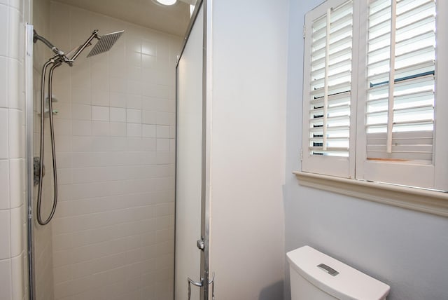 bathroom with toilet and an enclosed shower