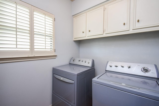 laundry area featuring cabinets and separate washer and dryer