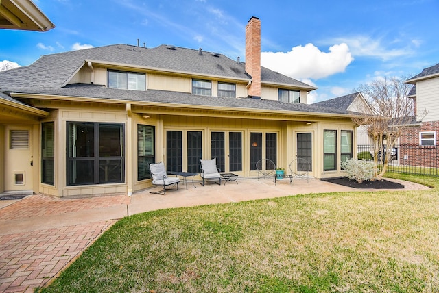 rear view of property with a patio and a yard