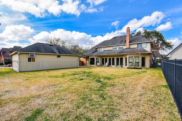 rear view of property featuring a yard