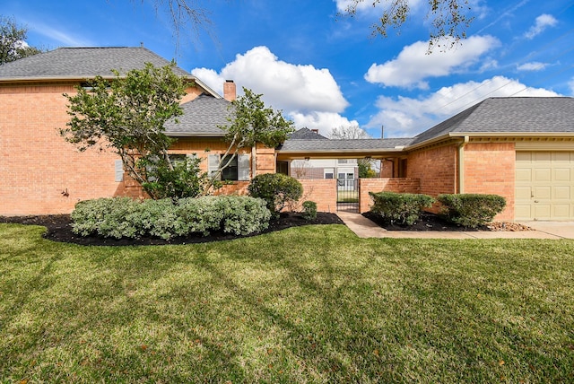 view of front of house with a garage and a front yard