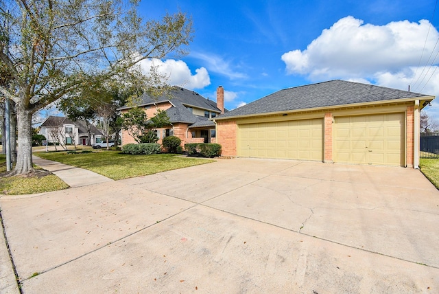 view of front facade with a garage and a front lawn